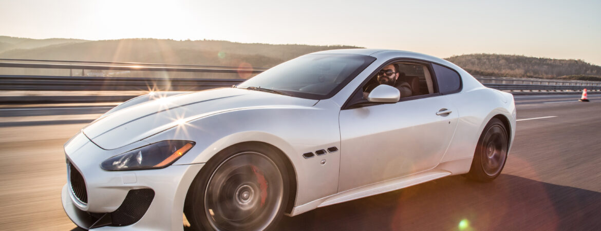 WHite bmw car on a road