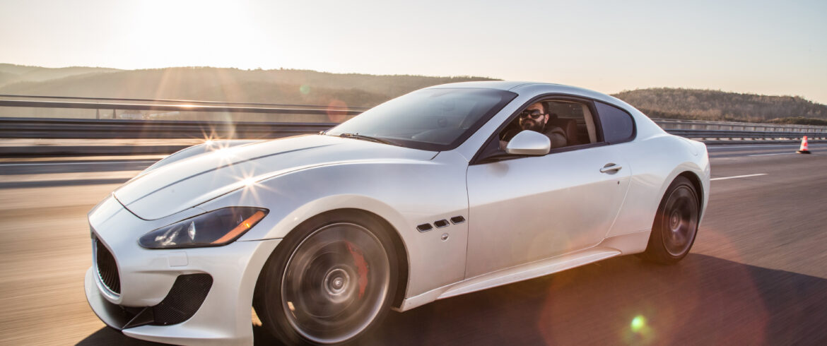 WHite bmw car on a road