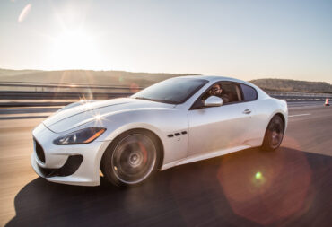 WHite bmw car on a road